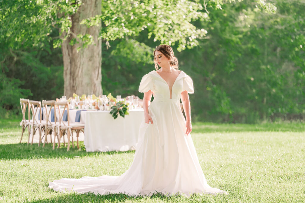 A playful brunette bride enjoying her summer outdoor bridal portrait session at Firefly Haven by JoLynn Photography