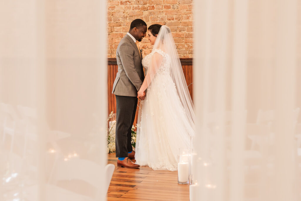 A newly wed couple on their wedding day enjoying their Wake Forest wedding photography session by JoLynn Photography