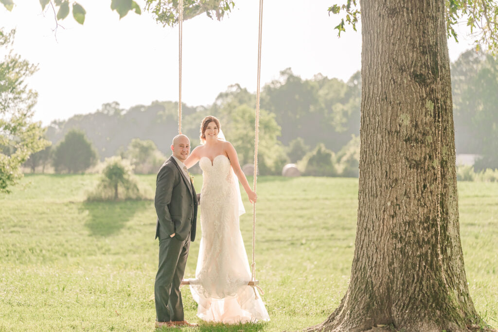 A loving couple enjoying their Winston-Salem wedding in the illuminating countryside at sunset