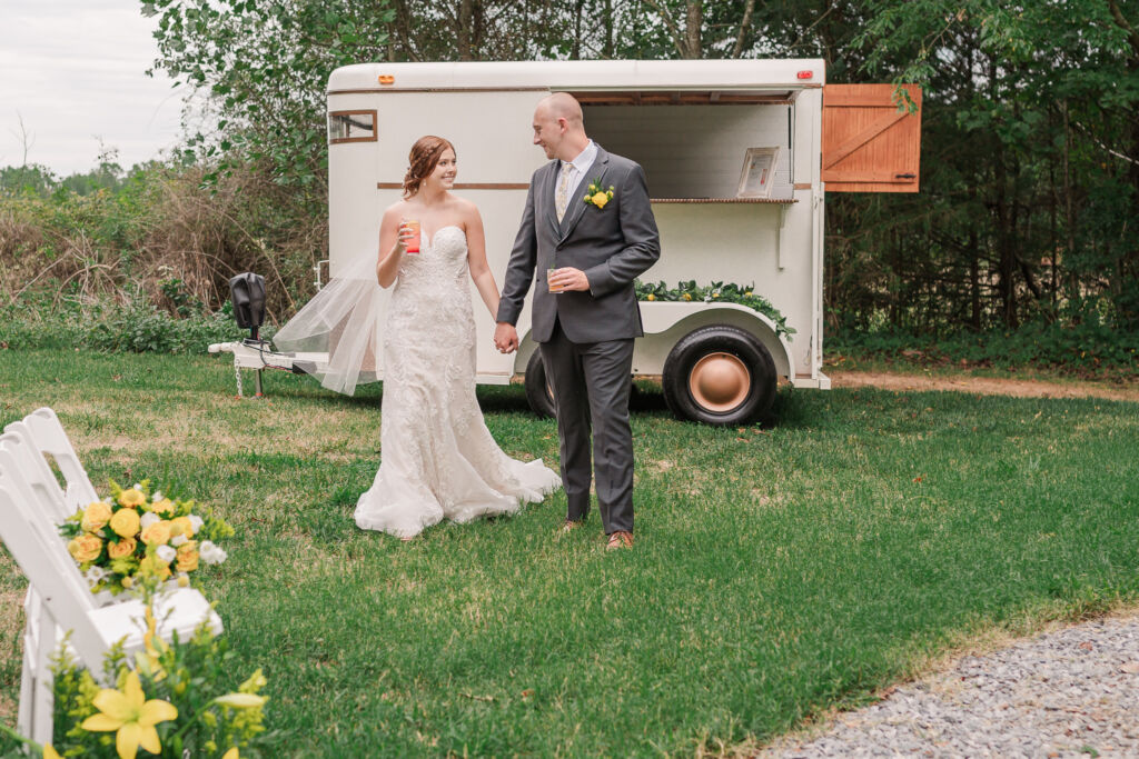 A loving couple enjoying their Winston-Salem wedding in the illuminating countryside at sunset