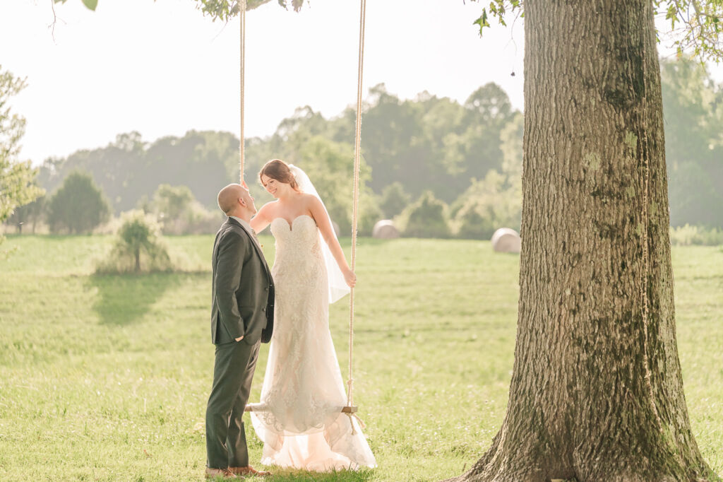 A loving couple enjoying their Winston-Salem wedding in the illuminating countryside at sunset