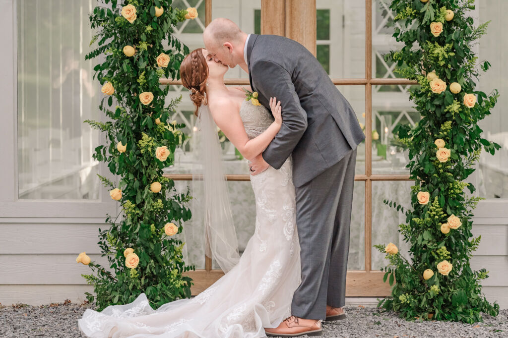 A loving couple enjoying their Winston-Salem wedding in the illuminating countryside at sunset