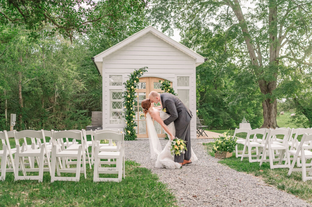 A loving couple enjoying their Winston-Salem wedding in the illuminating countryside at sunset