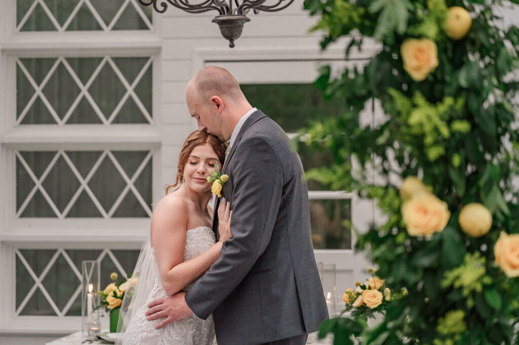 A loving couple enjoying their Winston-Salem wedding in the illuminating countryside at sunset