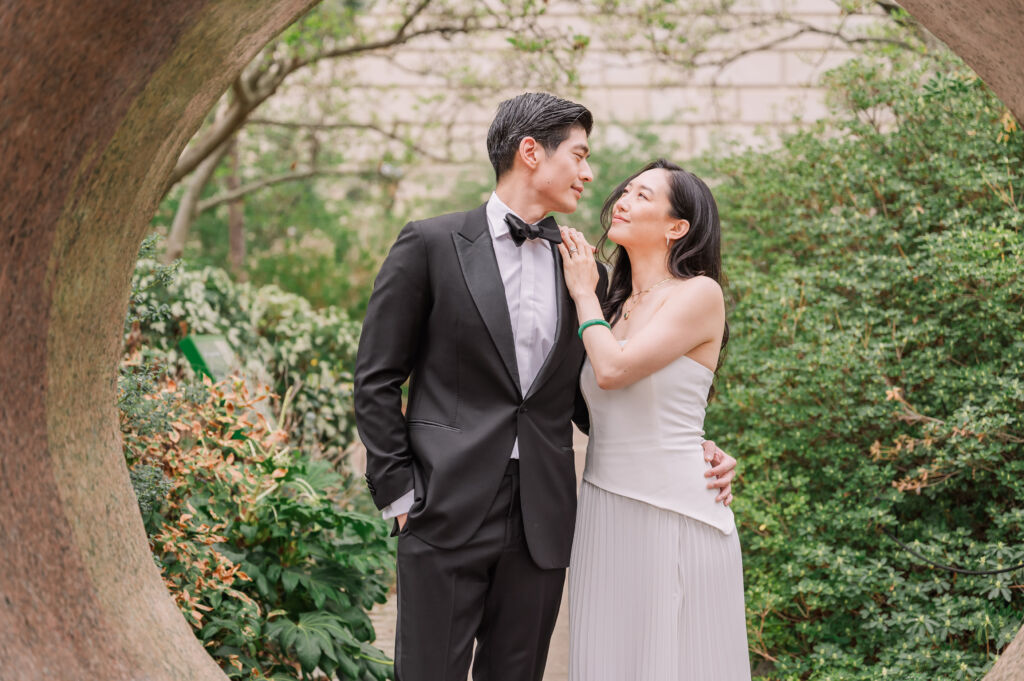 A loving happy Asian couple celebrating their spring engagement next to iconic DC monuments by Washington DC wedding photographer, JoLynn Photography
