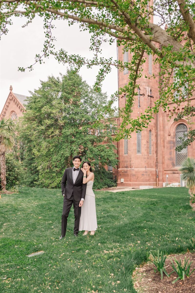 Newlyweds snuggle in the back garden with big smiles in black and white thanks to their North Carolina wedding planners