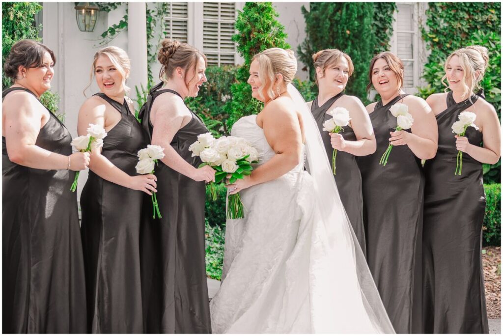 A happy bride enjoying her bridal portrait session by JoLynn Photography during her summer wedding day at The Finch House