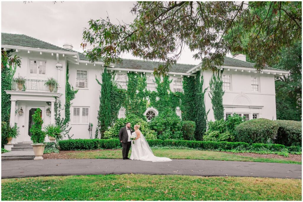 A first look on a stunning summer wedding day at The Finch House as the couple is surrounded by bright greenery by JoLynn Photography