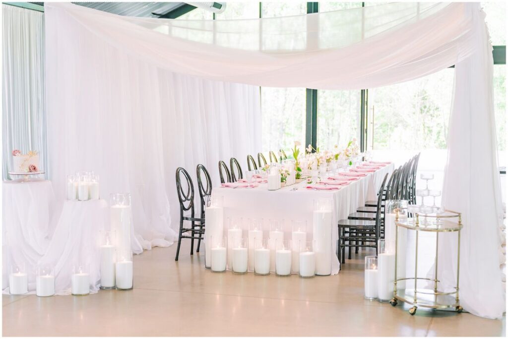 A stunning spring editorial with soft pink florals and warm lighting under romantic drapery at The Skyroom by JoLynn Photography