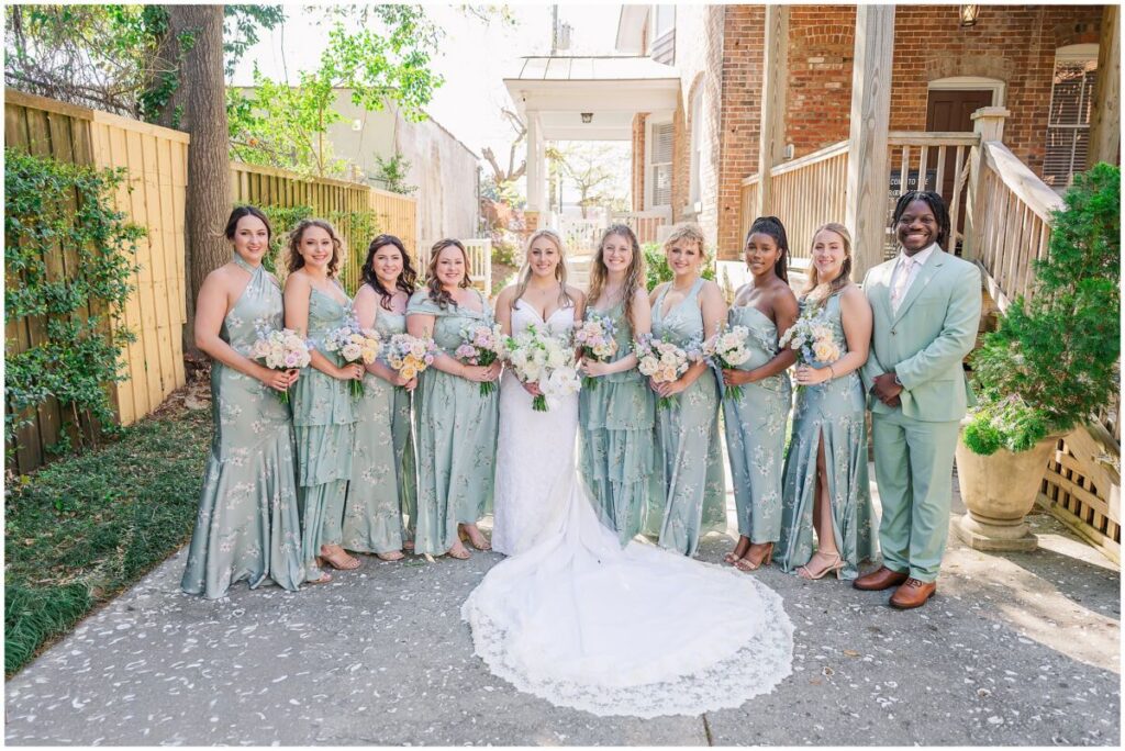 A glowing bride with her beautiful bridesmaids in green dresses in Wilmington North Carolina