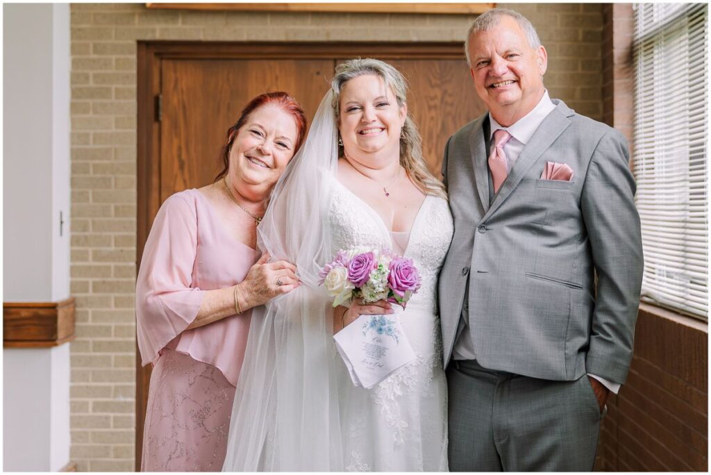 A blushing bride and a first look on her wedding day with her dad at their family church