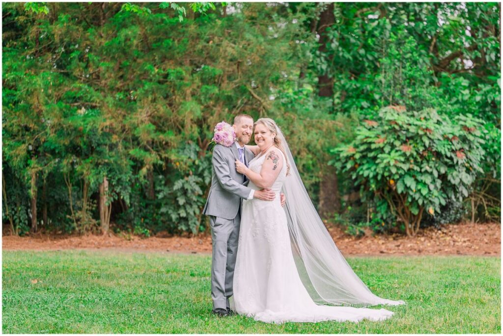 A happy couple on their summer wedding day in a beautiful green park at sunset at Terra Blooms Farm by JoLynn Photography