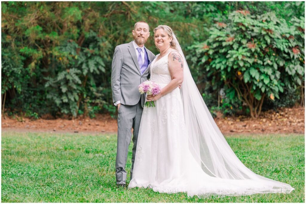 A happy couple on their summer wedding day in a beautiful green park at sunset at Terra Blooms Farm by JoLynn Photography