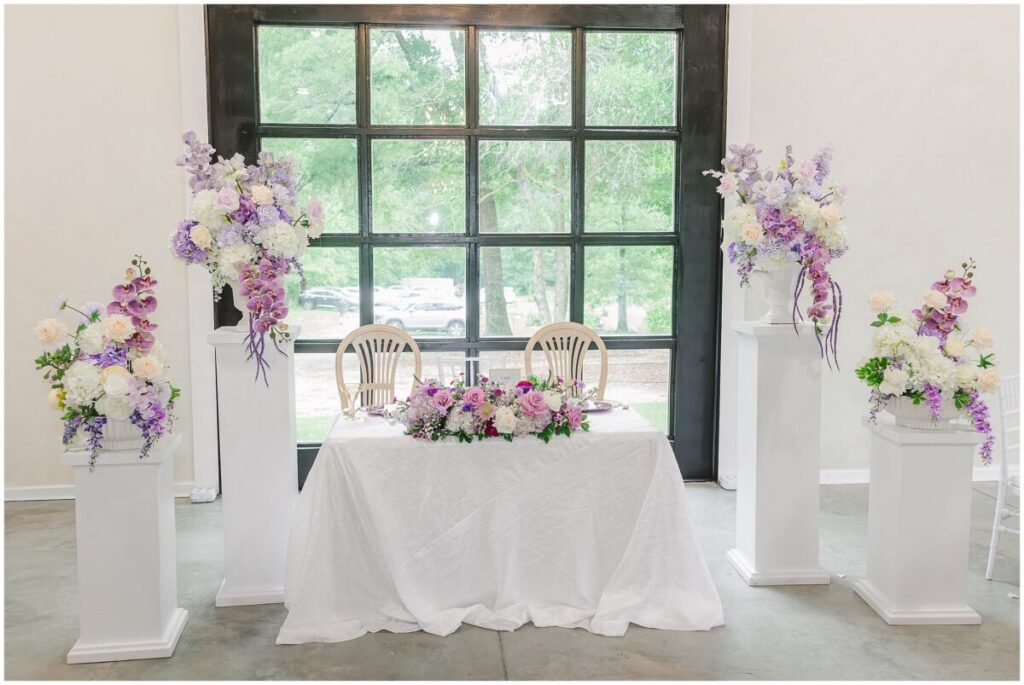 A wedding reception at Terra Bloom Farms filled with warm summer flowers, purples, and pops of gold by JoLynn Photography