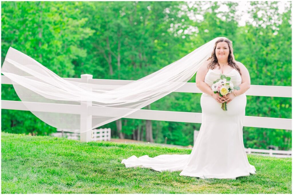 A blushing bride enjoying her bridal portrait session at The Barn at Blue Sky Farm by JoLynn Photography