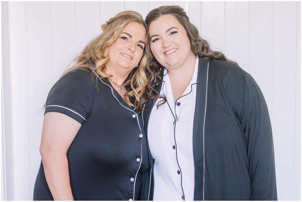 A bride and her mom in matching robes on her wedding day