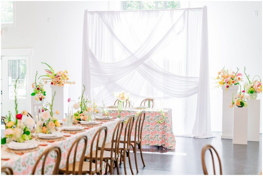 A vibrant wedding reception full or bright warm colors during a stunning wedding at Stone Manor by JoLynn Photography