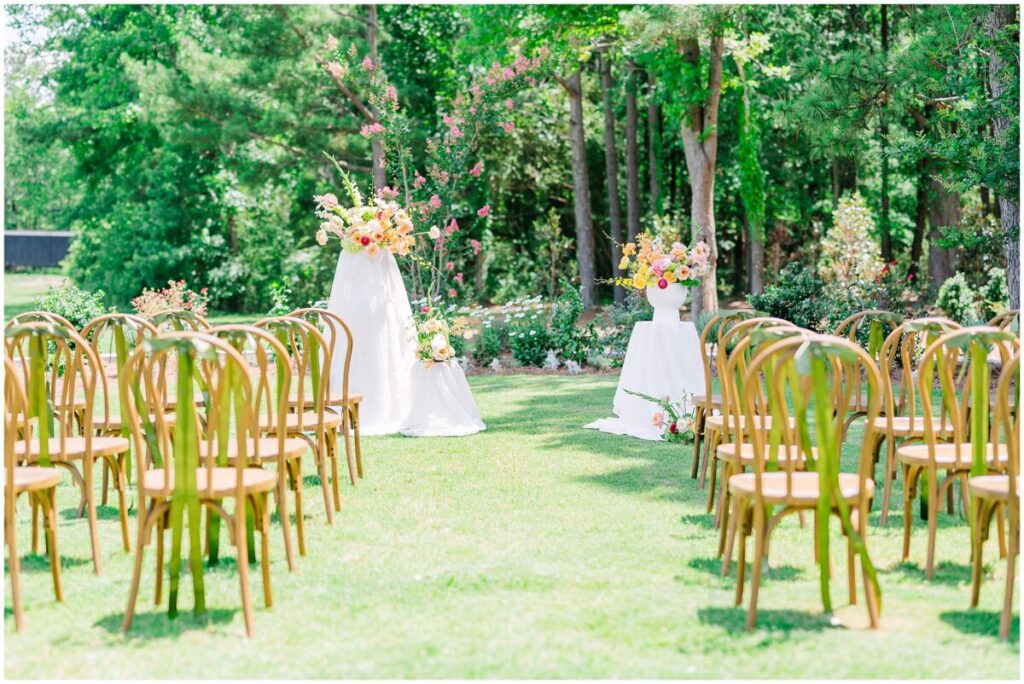 A bright summer afternoon full of vibrant colors at a ceremony site at Stone Manor by JoLynn Photography