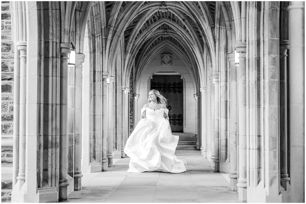A bride running down the halls at Duke Chapel during her bridal portrait session with JoLynn Photography