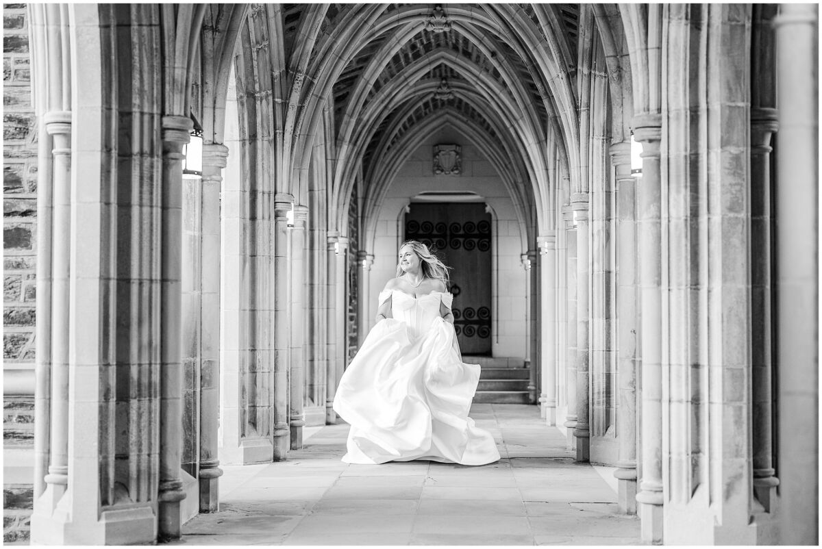 A bride running down the halls at Duke Chapel during her bridal portrait session with JoLynn Photography